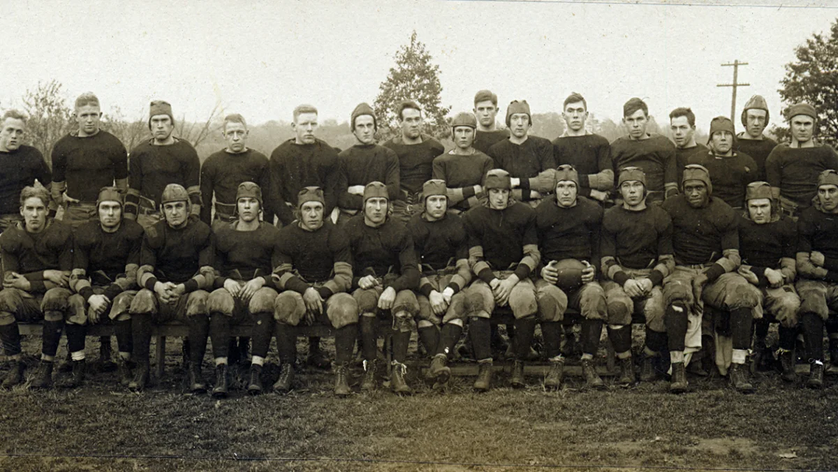 The 1918 Rutgers football team posed in two rows, wearing uniforms and leather helmets.